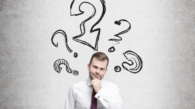 Young businessman is thinking about complicated questions.